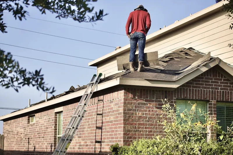Professional roofer working on a residential roof in Fairbanks